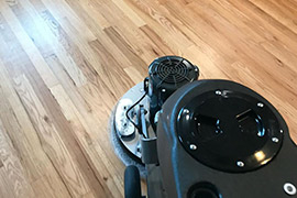 cleaning hardwood floor with special equipment in Aptos